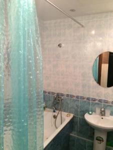 a bathroom with a shower and a sink and a tub at Apartment Erofey Arena at Morozova 87 in Khabarovsk +21 photos
