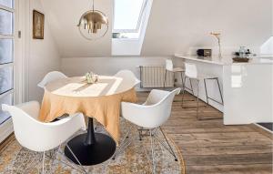 a dining room with a table and white chairs at 2 Bedroom Nice Apartment In Faaborg in Faaborg
