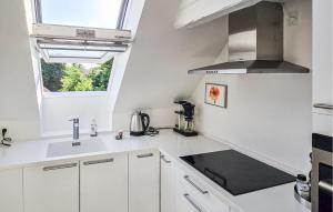 a white kitchen with a sink and a window at 2 Bedroom Nice Apartment In Faaborg in Faaborg