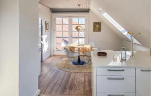 a kitchen and dining room with a table and chairs at 2 Bedroom Nice Apartment In Faaborg in Faaborg +9 photos
