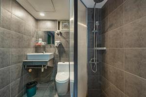 a bathroom with a toilet and a sink and a shower at BKK39 Airport Hotel in Lat Krabang +85 photos