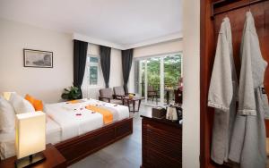a bedroom with a bed and a balcony at Indra Angkor Hotel in Siem Reap +38 photos