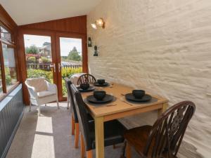 a dining room with a wooden table and chairs at West End House in Bradford
