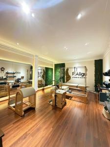 a large room with a hair salon with wooden floors at Hanoi Little Town Hotel in Hanoi