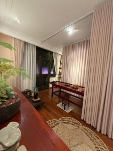 a living room with a table and a bench at Hanoi Little Town Hotel in Hanoi
