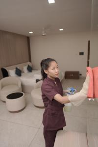 a woman standing in a room with toilets at Empire Suites in Erāttupetta