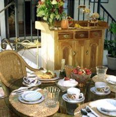 a table with plates and bowls of food on it at Spanish Villa Inn in St. Helena