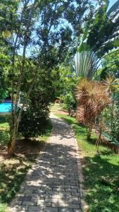 a path in a park with trees and a sidewalk at Machan Villa in Tangalle