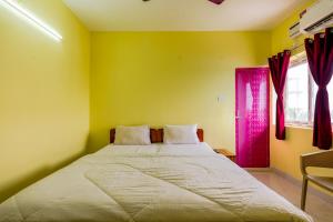 a bedroom with a large bed and a window at Subham Residency in Chennai