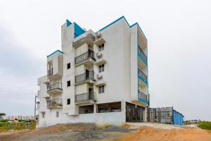 a white building on top of a pile of dirt at Subham Residency in Chennai