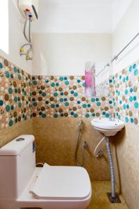 a bathroom with a toilet and a sink at Subham Residency in Chennai