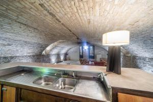 a kitchen with a sink and a brick wall at Le Chai des Écluses 4-étoiles gîtes in Saint-Léger-sur-Dheune +35 photos