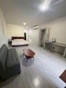 a room with a bed and a couch and a table at I mee Lanta Home in Phra Ae beach