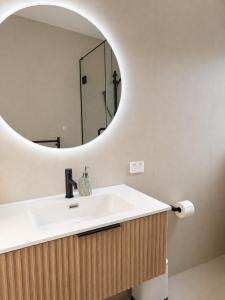 a bathroom with a sink and a mirror at The palms farmhouse in Puketona