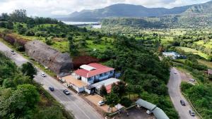 arial view of a house on a hill with a road at Hotel green hills in Waki