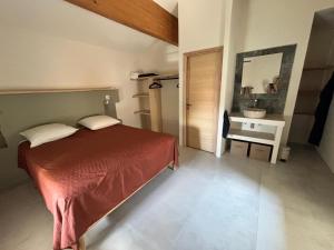 a bedroom with a bed and a mirror and a sink at Maison éla in Bessas +14 photos