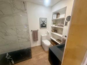 a bathroom with a toilet and a glass shower at La Pergola-1 in Quebec City +7 photos