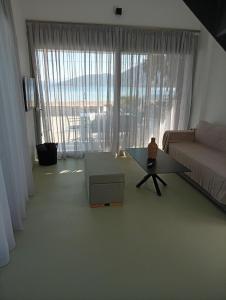 a living room with a couch and a table at Almira Seaside Suites in Áyios Dhimítrios