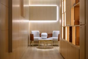 a room with two chairs and a table at INNSiDE by Meliá Braga Centro in Braga +26 photos