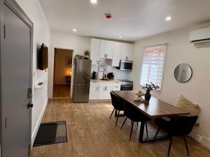 a kitchen with a wooden table and a kitchen with a refrigerator at La Pergola-1 in Quebec City