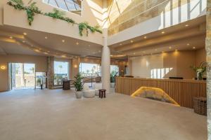 a lobby of a building with plants on the ceilings at Hotel Blue Sea Beach, Affiliated by Meliá in Stalís