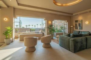 a living room with a couch and two chairs at Hotel Blue Sea Beach, Affiliated by Meliá in Stalís