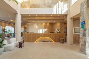 a lobby with a pool in the center of a building at Hotel Blue Sea Beach, Affiliated by Meliá in Stalís