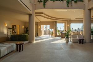 a living room with a couch and chairs in a building at Hotel Blue Sea Beach, Affiliated by Meliá in Stalís +126 photos