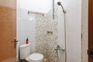 a bathroom with a toilet and a shower at RedDoorz @ Jalan Danau Limboto in Malang +22 photos