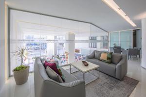 a living room with two couches and a table at Meliá Maputo Sky in Maputo