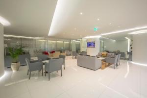 a lobby with chairs and tables in a building at Meliá Maputo Sky in Maputo