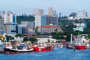 a group of boats docked in a harbor in a city at Meliá Maputo Sky in Maputo