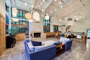 a living room with blue couches and a fireplace at Fujisan Lodge En in Fujikawaguchiko