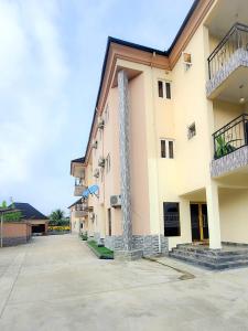 a building with a column on the side of it at Cogent Apartments and Hotel in Uyo