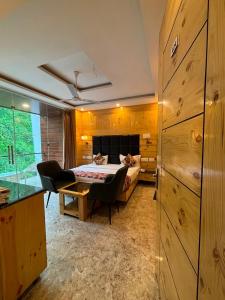 a bedroom with a bed and a desk with a chair at Hotel Classic Crown - #Scenic mountain view #open terrace #guest preferred #best selling hotel in Mussoorie in Mussoorie