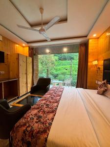 a bedroom with a large bed and a window at Hotel Classic Crown - #Scenic mountain view #open terrace #guest preferred #best selling hotel in Mussoorie in Mussoorie