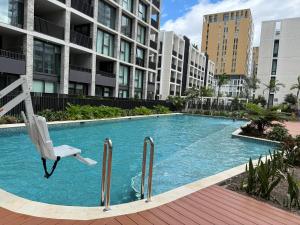 a chair in a swimming pool in a building at Olympic park 2Bed2Bath Apt with Pool - Free Gym and Car Park in Sydney