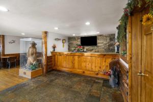 a living room with a stone wall and a television at Super 8 by Wyndham Jackson Hole in Jackson