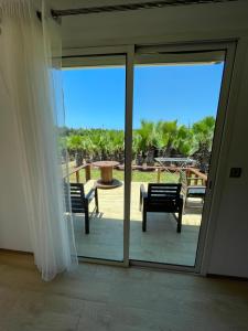 a sliding glass door with a view of a patio at palmeraie4 in Skhirat