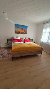 a bedroom with a large bed with red pillows at Panzers Ferienwohnungen in Asparn an der Zaya