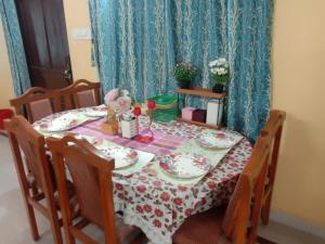 a dining room table with a red and white table cloth at Two BHK and Four BHK Fully Furnished Flats for 1 to 13 guests - Near Charminar and Salar Jung Museum in Hyderabad