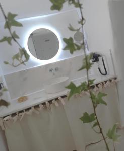 a bathroom sink with a mirror on the wall at Kamara since 1900 in Archangelos +6 photos
