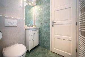 a bathroom with a toilet and a sink at Apartment & Rooms Three Angels in Baška +48 photos