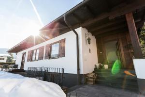 a house with the sun shining on the front of it at Bungalow Nr. 33 in Altenmarkt im Pongau
