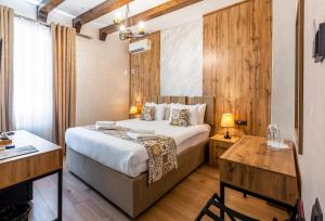 a hotel room with a bed and a desk at Khan Hotel Bukhara Old Town in Bukhara