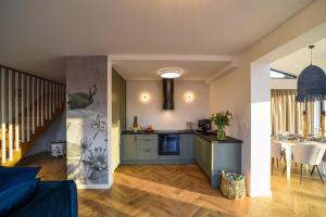a kitchen and living room with a blue couch at Velur Haus in Borne Sulinowo