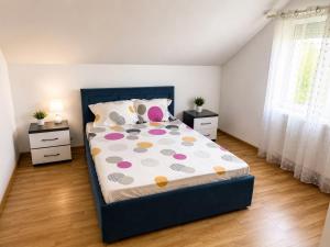 a bedroom with a bed and two night stands at Vila Ioana in Ştefăneşti