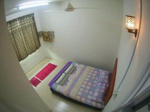a small room with a bed and a window at MARMA Homestay Melaka in Ayer Keroh