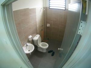 a bathroom with a toilet and a sink at MARMA Homestay Melaka in Ayer Keroh