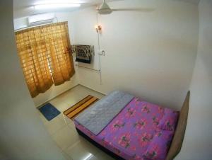 a small bed in a room with a window at MARMA Homestay Melaka in Ayer Keroh
